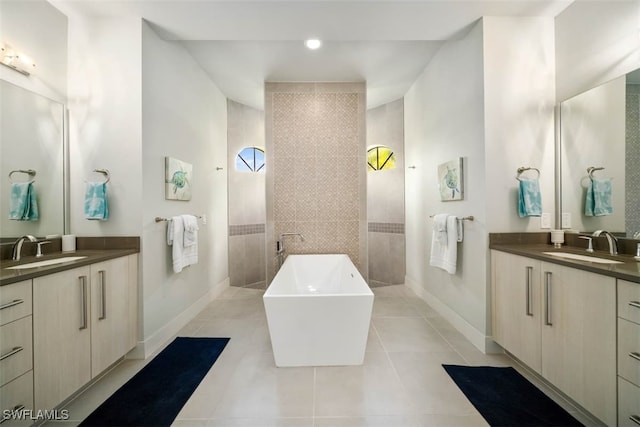 bathroom with a shower, vanity, and tile patterned floors