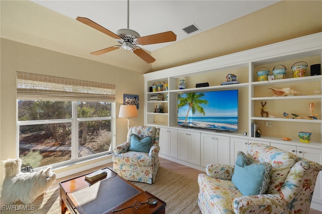 living room with ceiling fan and light hardwood / wood-style flooring