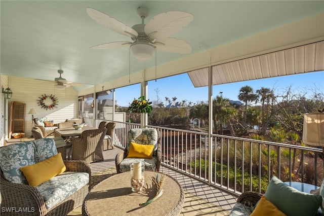 sunroom / solarium featuring ceiling fan