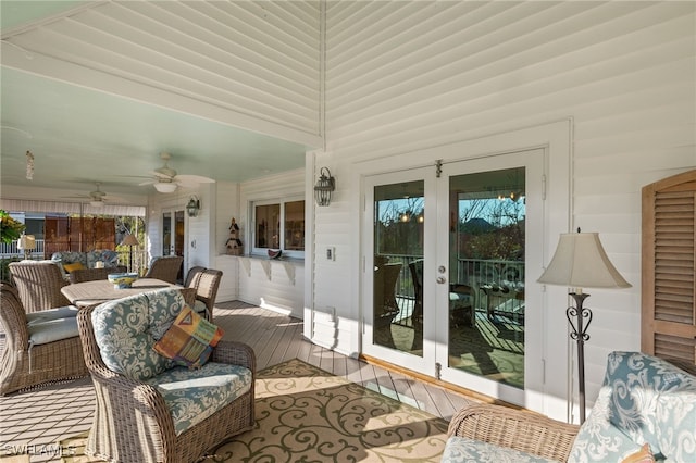 sunroom featuring ceiling fan and french doors