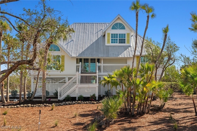 rear view of property featuring a porch