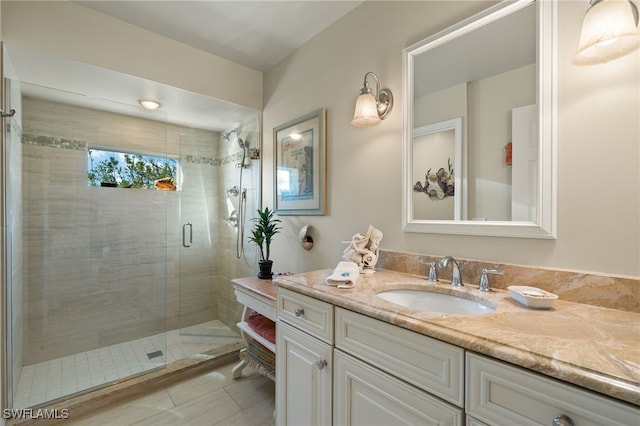 bathroom with vanity and a shower with door