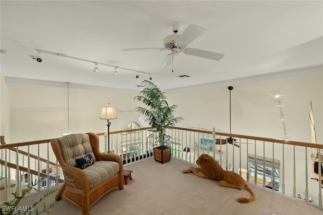 sitting room featuring carpet flooring, track lighting, and ceiling fan