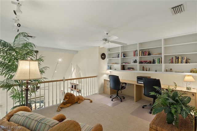 carpeted office space with ceiling fan