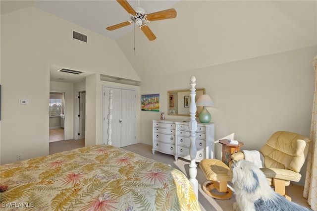 bedroom featuring ceiling fan, a closet, high vaulted ceiling, and light carpet