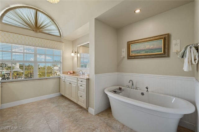 bathroom with vanity and a bath