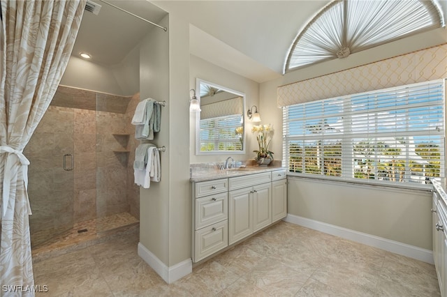 bathroom featuring vanity and a shower with door