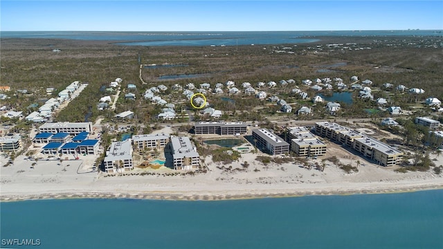 drone / aerial view featuring a water view and a view of the beach