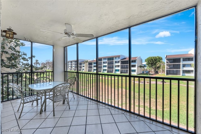 unfurnished sunroom with ceiling fan