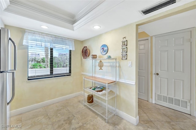 corridor with a tray ceiling and crown molding