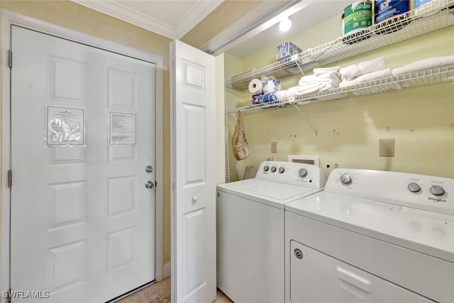 clothes washing area with crown molding and washer and dryer