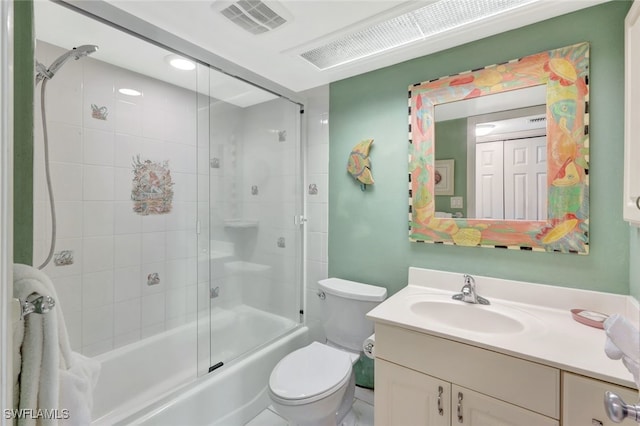 full bathroom featuring vanity, enclosed tub / shower combo, and toilet