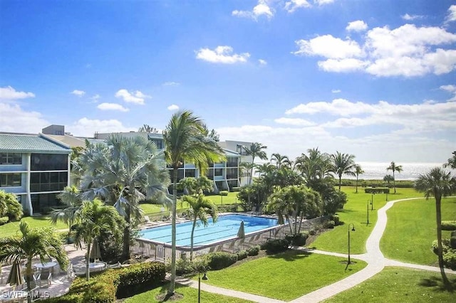 view of swimming pool featuring a lawn