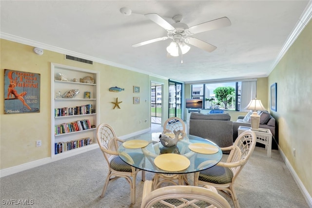 dining room featuring light carpet, ornamental molding, built in features, and ceiling fan