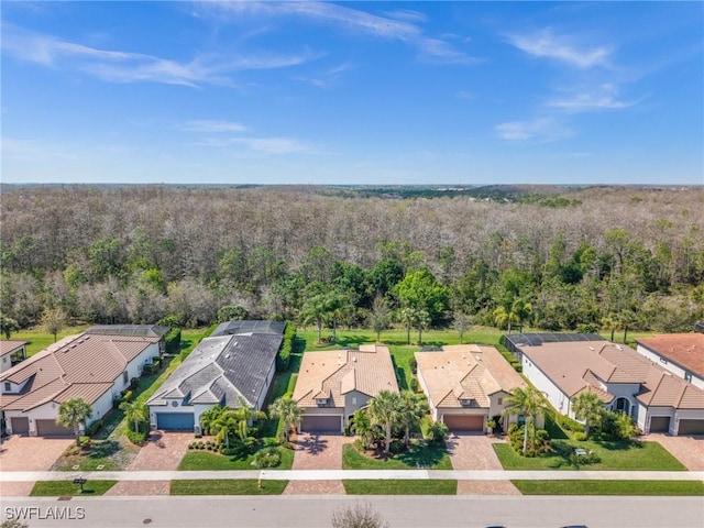 bird's eye view featuring a residential view and a wooded view