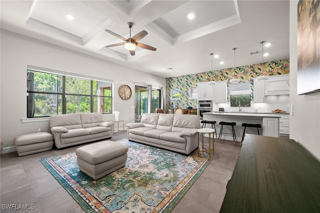 living room featuring baseboards, visible vents, coffered ceiling, and crown molding