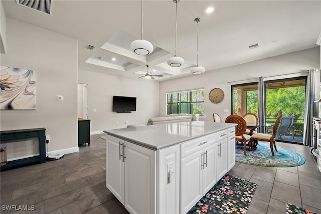 kitchen featuring beamed ceiling, coffered ceiling, visible vents, and white cabinetry