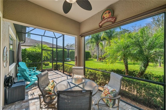 sunroom featuring a ceiling fan