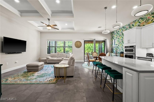 living room featuring ceiling fan, coffered ceiling, baseboards, beam ceiling, and crown molding