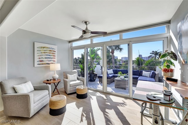 sunroom / solarium featuring ceiling fan