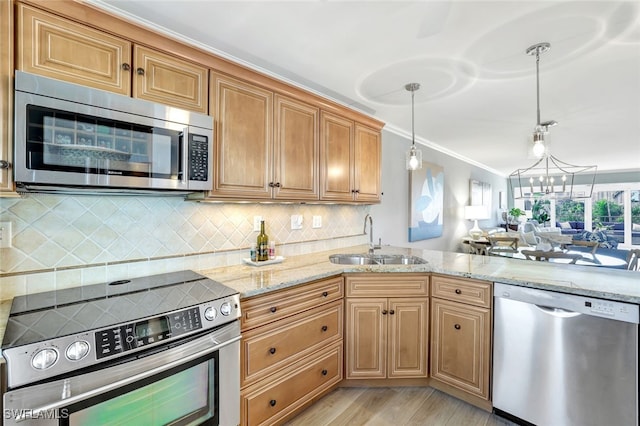 kitchen featuring sink, crown molding, appliances with stainless steel finishes, decorative backsplash, and decorative light fixtures