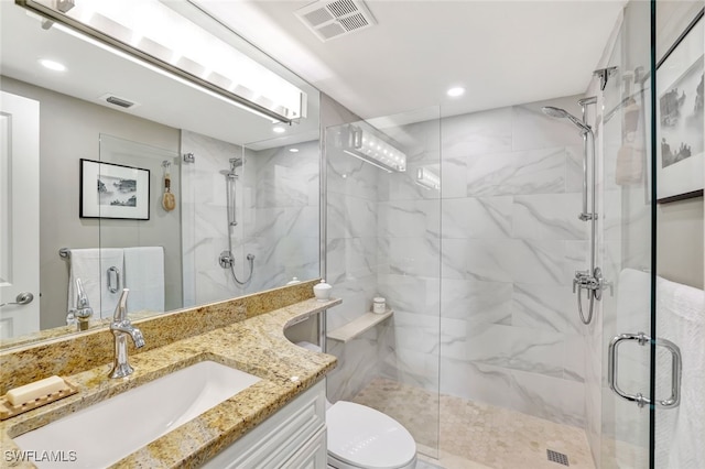 bathroom with vanity, toilet, and an enclosed shower