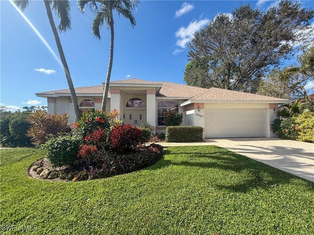 view of front of property featuring a garage and a front lawn