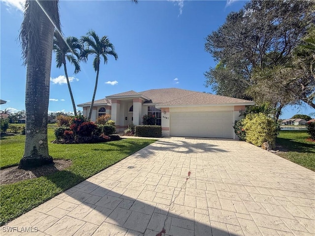 view of front of property featuring a garage and a front yard