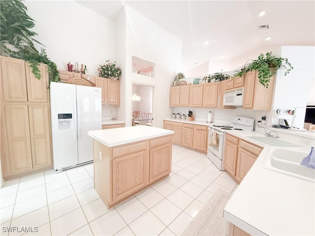 kitchen with light brown cabinetry, sink, light tile patterned floors, a kitchen island, and white appliances