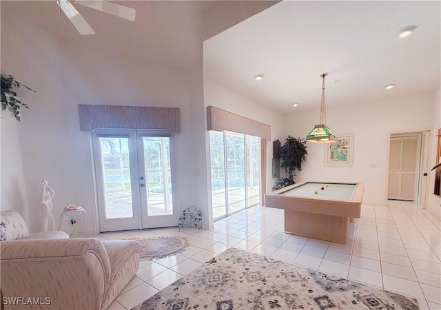 playroom with plenty of natural light, billiards, light tile patterned floors, and french doors