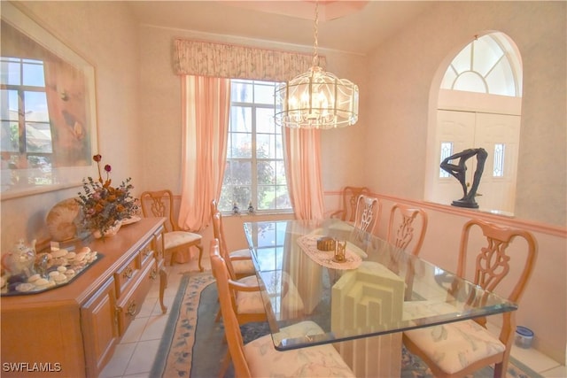 dining area with light tile patterned floors and a chandelier