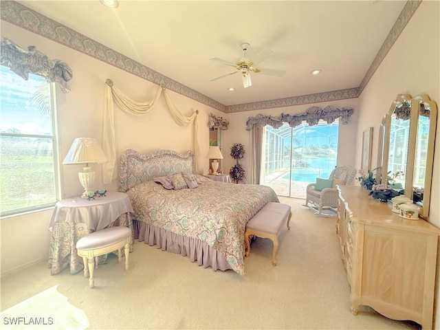 carpeted bedroom featuring multiple windows, access to exterior, and ceiling fan