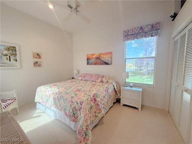 carpeted bedroom featuring a closet and ceiling fan