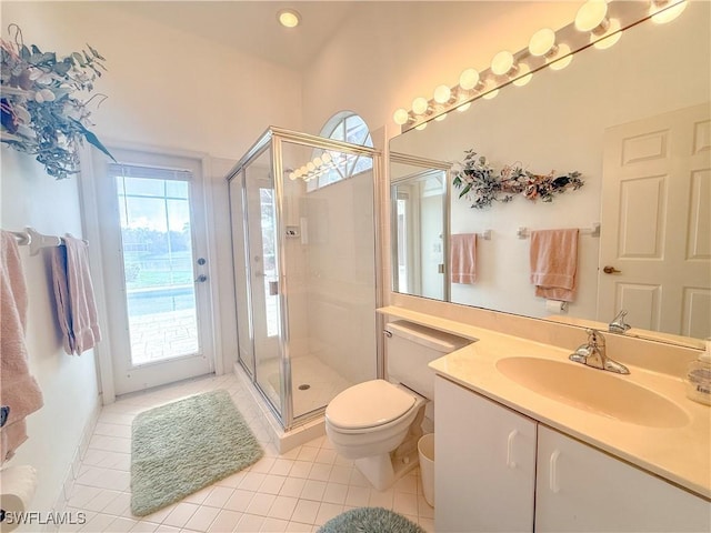 bathroom featuring a shower with door, vanity, tile patterned flooring, and toilet