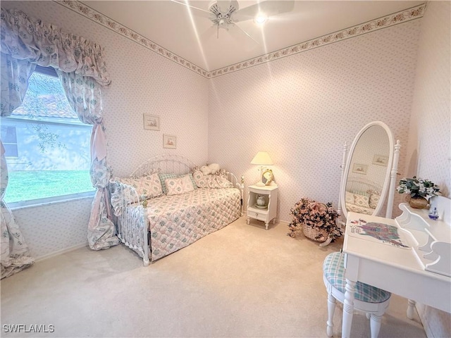 bedroom featuring multiple windows, ceiling fan, and carpet