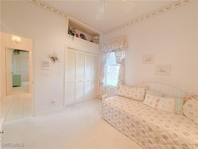 unfurnished bedroom with a closet, ceiling fan, and carpet