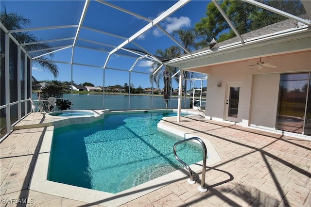 view of pool featuring a lanai, ceiling fan, a patio, a water view, and an in ground hot tub