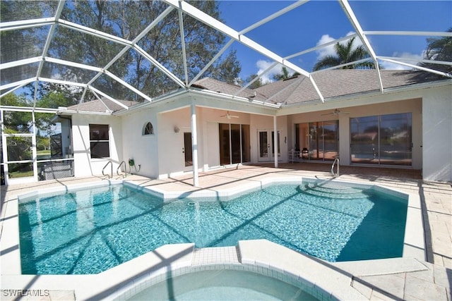 view of swimming pool featuring an in ground hot tub, ceiling fan, a patio area, and glass enclosure