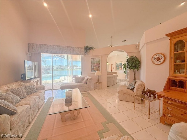 tiled living room featuring high vaulted ceiling and ceiling fan