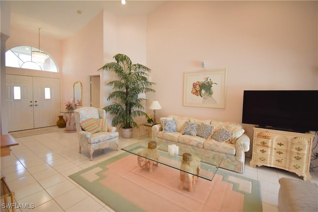 living room featuring a high ceiling and light tile patterned floors