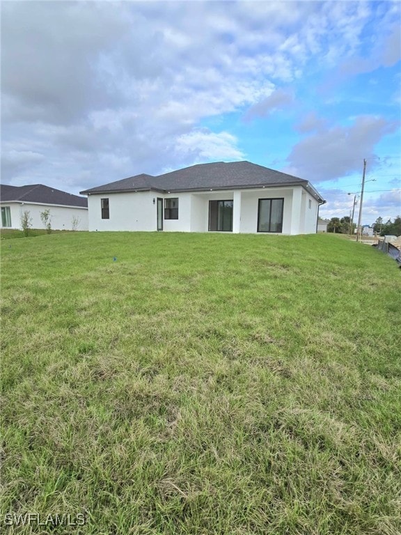 back of house with a lawn