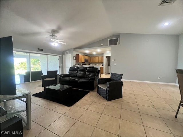 living area with lofted ceiling, ceiling fan, light tile patterned floors, and baseboards