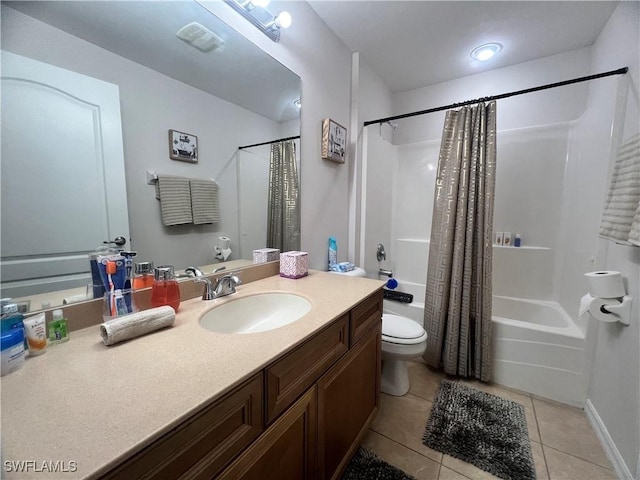 full bathroom featuring tile patterned floors, shower / bath combo with shower curtain, toilet, and vanity
