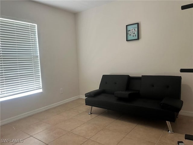 sitting room featuring baseboards and light tile patterned flooring