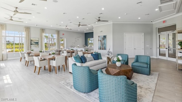 2609 Table Coral Trl, North Fort Myers, FL 33903 - living area with a ceiling fan, ornamental molding, baseboards, french doors, and light wood-style flooring