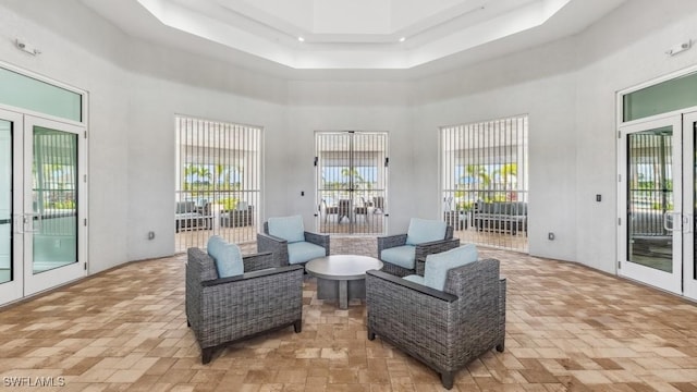 2609 Table Coral Trl, North Fort Myers, FL 33903 - sitting room with a towering ceiling, french doors, and a tray ceiling