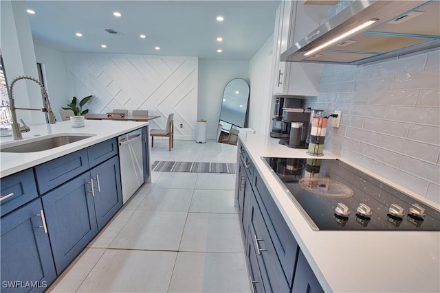 kitchen featuring dishwasher, sink, light tile patterned floors, wall chimney range hood, and black electric cooktop