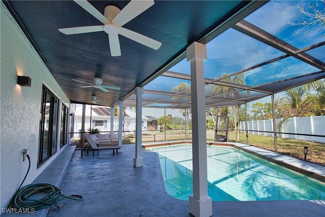 view of pool with a patio area and glass enclosure