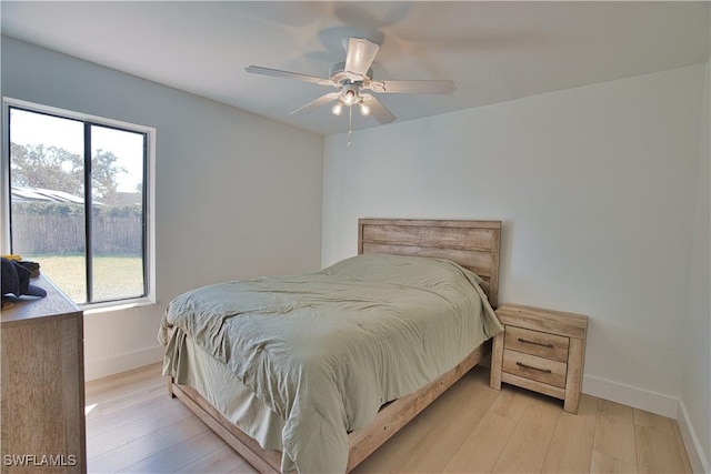 bedroom with light hardwood / wood-style flooring and ceiling fan