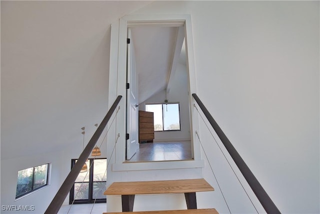 staircase with vaulted ceiling with beams